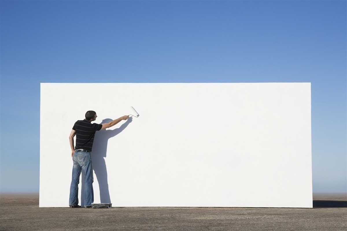 man painting wall with solar paint
