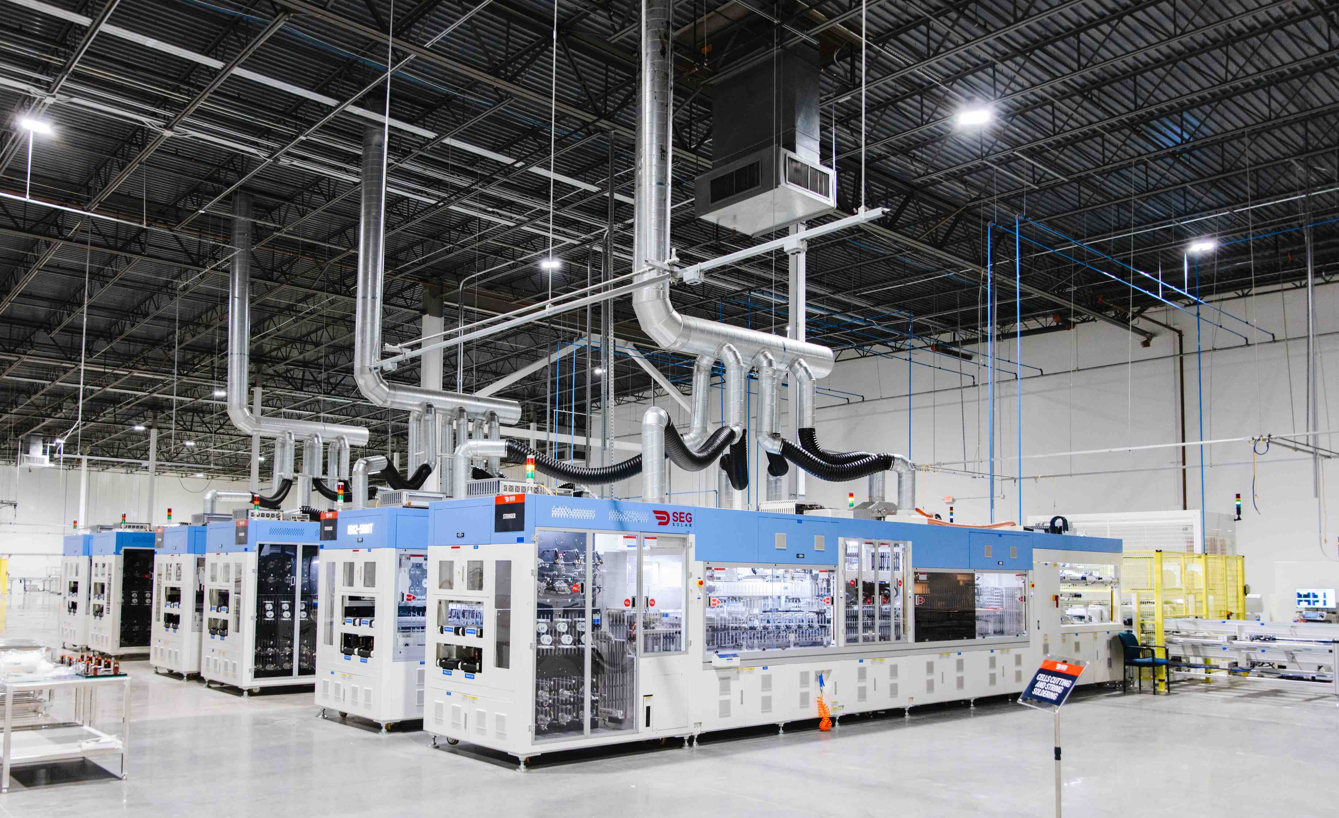 A photo showing several cell-stringing machines near the start of the production line at SEG Solar's Houston manufacturing plant.