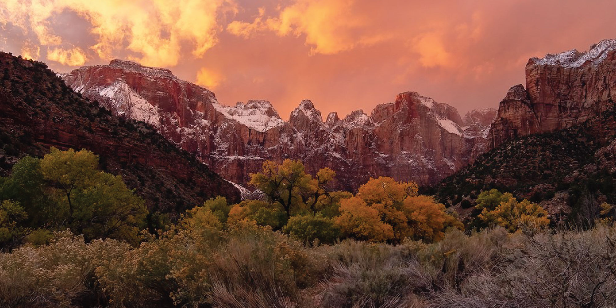 A view of Zion National Park's mountains at sunset.